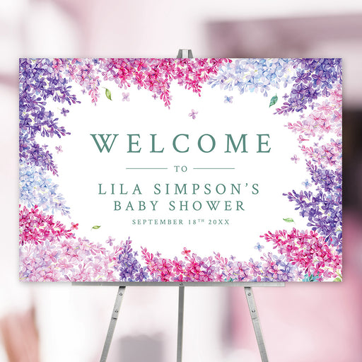 Custom floral welcome sign featuring pink and purple lilacs. Personalized baby shower sign ideal for spring celebrations.