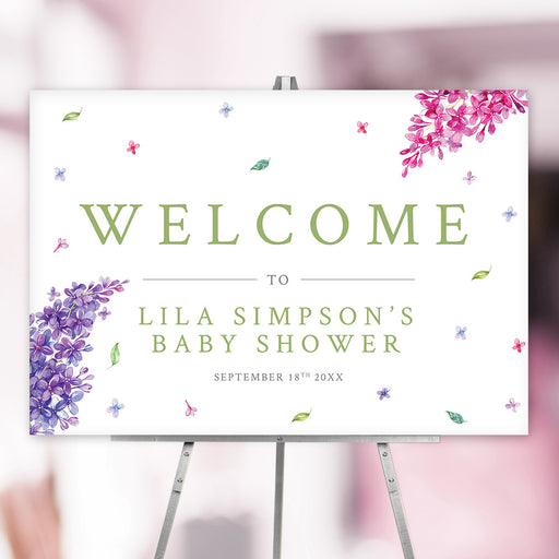 Elegant floral baby shower welcome sign featuring pink and purple lilacs, personalized with name and date.