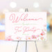 floral tea party welcome sign featuring pink watercolor flowers, elegant script lettering, and customizable event details.