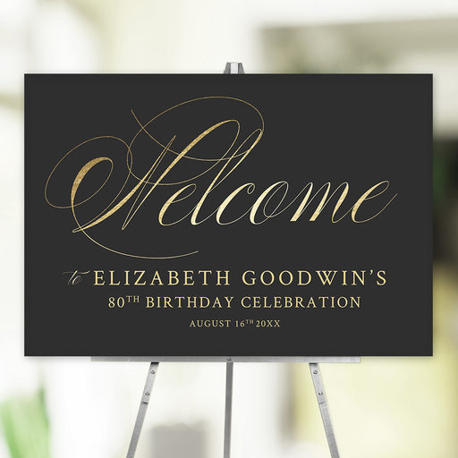 Elegant black and gold scripted welcome sign personalized with name, age, and event date, displayed on an easel for milestone birthdays or special occasions.