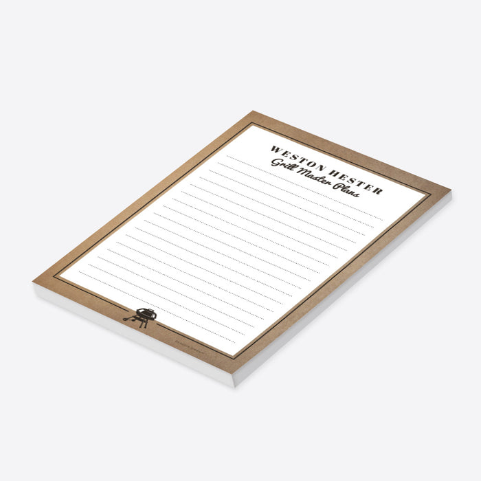 A personalized notepad titled "Grill Master Plans" with a rustic brown border and a small grill icon at the bottom.-side