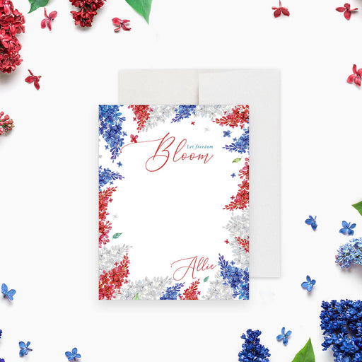 Patriotic floral note card featuring red, white, and blue flowers and “Let Freedom Bloom” text-front
