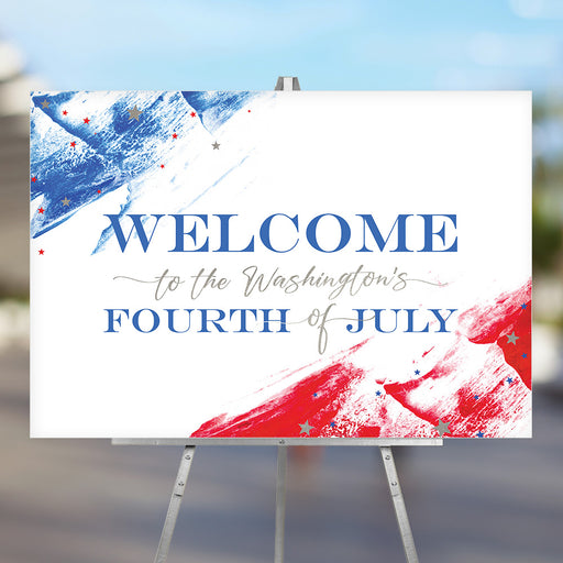 Custom Fourth of July welcome sign with red and blue paint strokes, patriotic stars, and personalized family name displayed on an easel for party entrance décor.