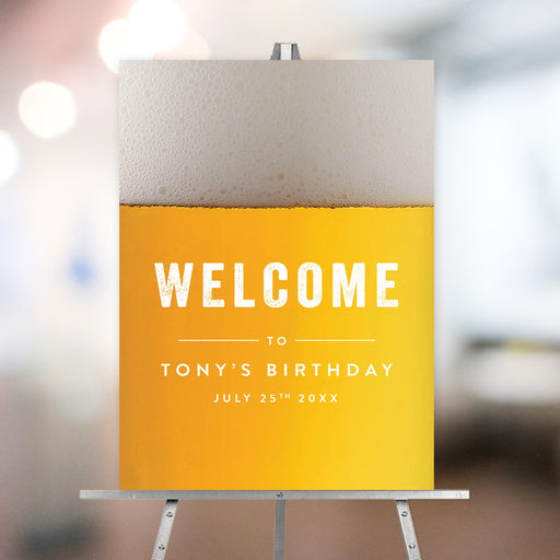 Custom birthday welcome sign with realistic beer foam and golden pint design, displayed on an easel for a milestone party.