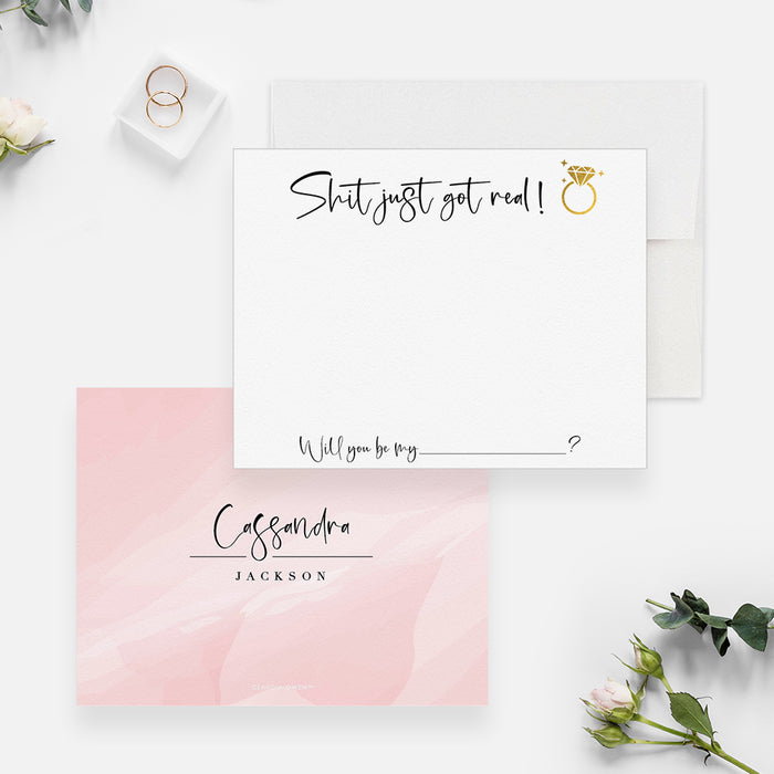 Funny bridesmaid proposal card with “Shit just got real!”, a printed gold ring and a customizable role; pink watercolor back with a name.