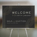 Black and gold welcome sign with geometric lines, customizable for business galas, auctions, and formal events.