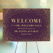 Personalized purple and gold welcome sign used as elegant event entrance decor for galas and formal celebrations