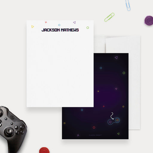 Personalized gamer note card with colorful game symbols, a dark purple controller design on the back and a white envelope.
