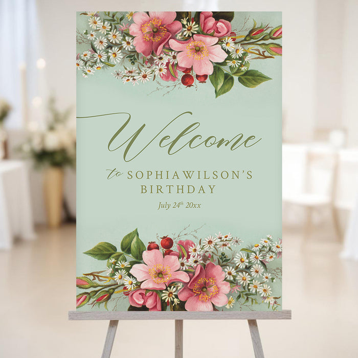garden party birthday welcome sign with vintage pink flowers, white daisies, sage green background, and elegant script lettering on an easel