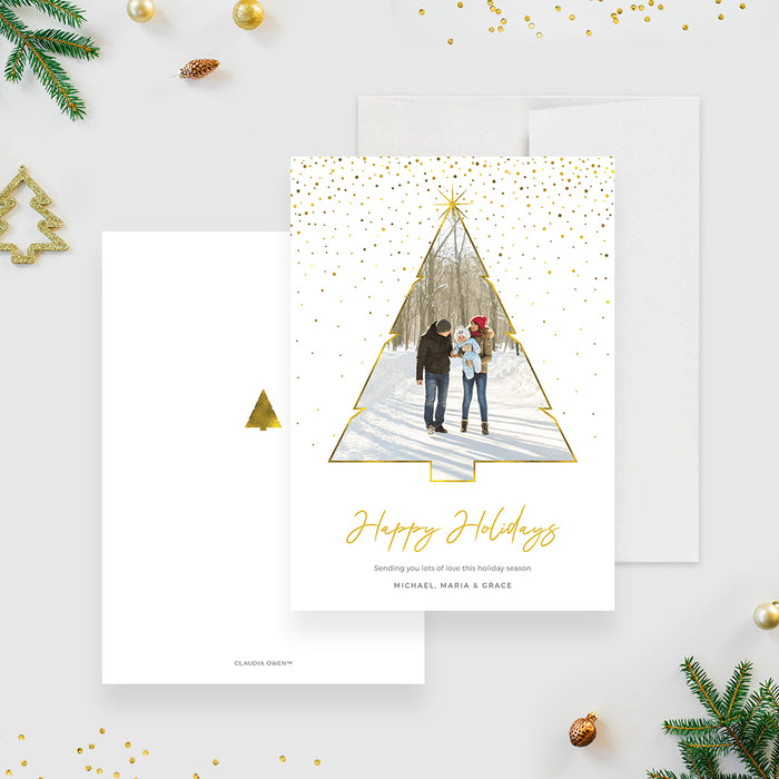 Elegant holiday photo card featuring a gold-outlined Christmas tree photo frame, gold confetti accents and modern script Happy Holidays typography on a white background.