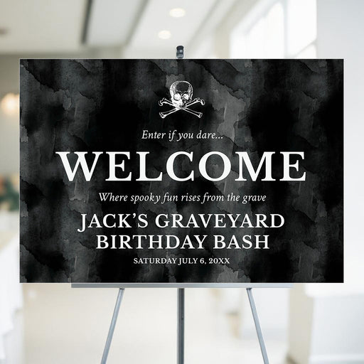 gothic birthday welcome sign with a black watercolor background, skull-and-crossbones illustration, custom birthday wording for a spooky party entrance.