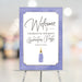 Lavender graduation welcome sign with champagne bottle design, elegant décor for grad party or milestone celebration