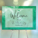 Green watercolor St. Patrick’s Day welcome sign with four-leaf clover, festive signage to greet guests at parties