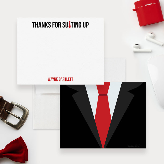 Groomsmen thank you card front and back, with “Thanks for suiting up,” a personalized name and a black suit with a red tie.