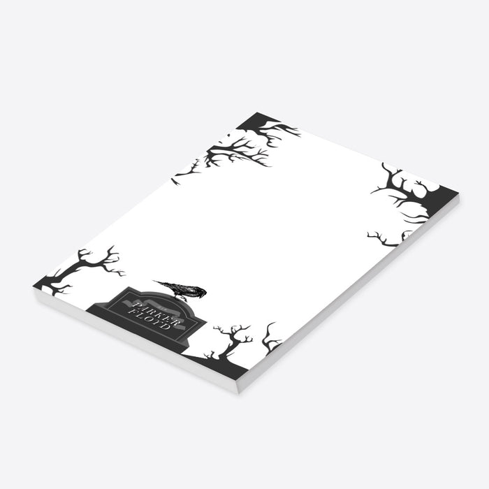 Custom notepad featuring a raven perched on a tombstone surrounded by bare trees — perfect creepy Halloween stationery or gothic gift.-side