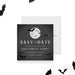 Halloween save the date card with a glowing full moon, flying bat silhouettes, and bold white text on a dark charcoal background-front