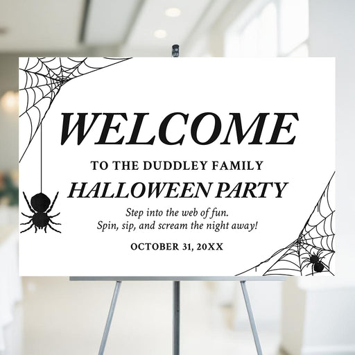 Halloween party welcome sign featuring spider web corners and hanging spiders with a clean black and white elegant design