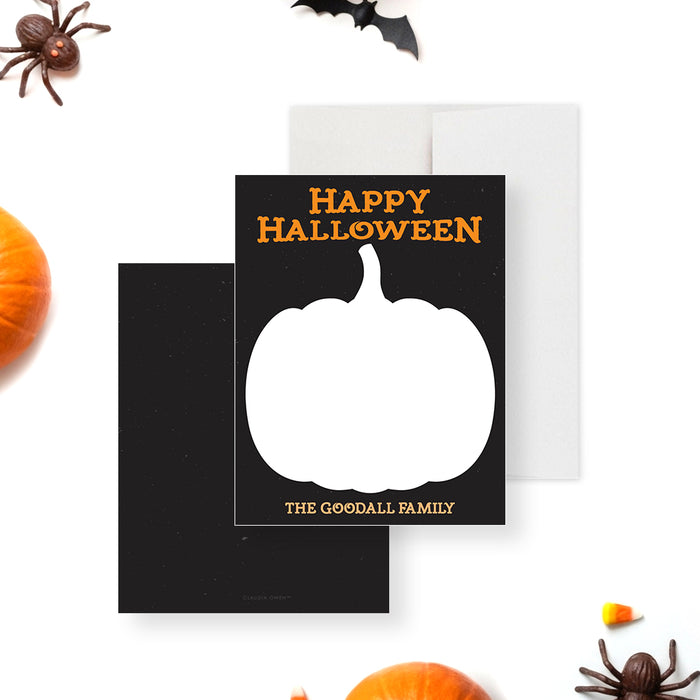 Halloween note card with a large pumpkin silhouette, a black background, and orange text that says "Happy Halloween."-front-back