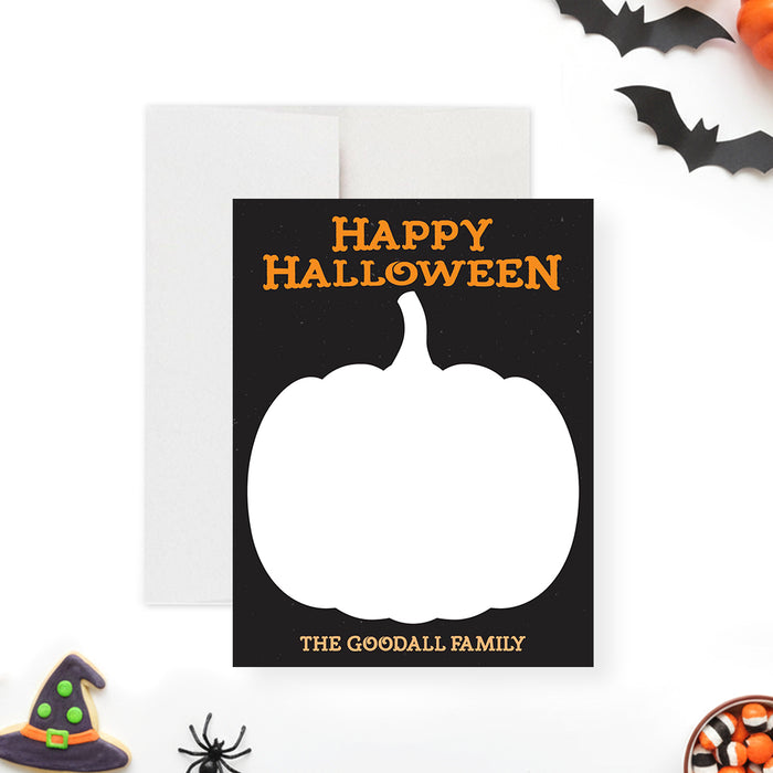 Halloween note card with a large pumpkin silhouette, a black background, and orange text that says "Happy Halloween."-front