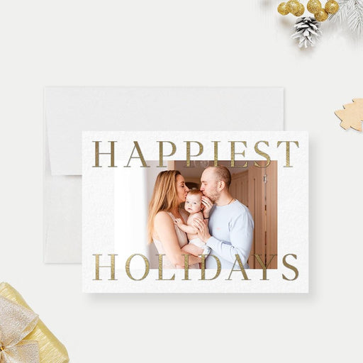 Happiest Holidays Christmas photo card template with gold lettering, a family photo and a white background.