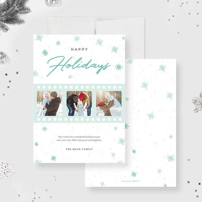 Happy holidays photo card featuring mint green film strip design and family photos