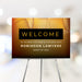 Customizable whiskey-inspired welcome sign with amber background and ice cube design, perfect for corporate happy hours, parties, and milestone events.
