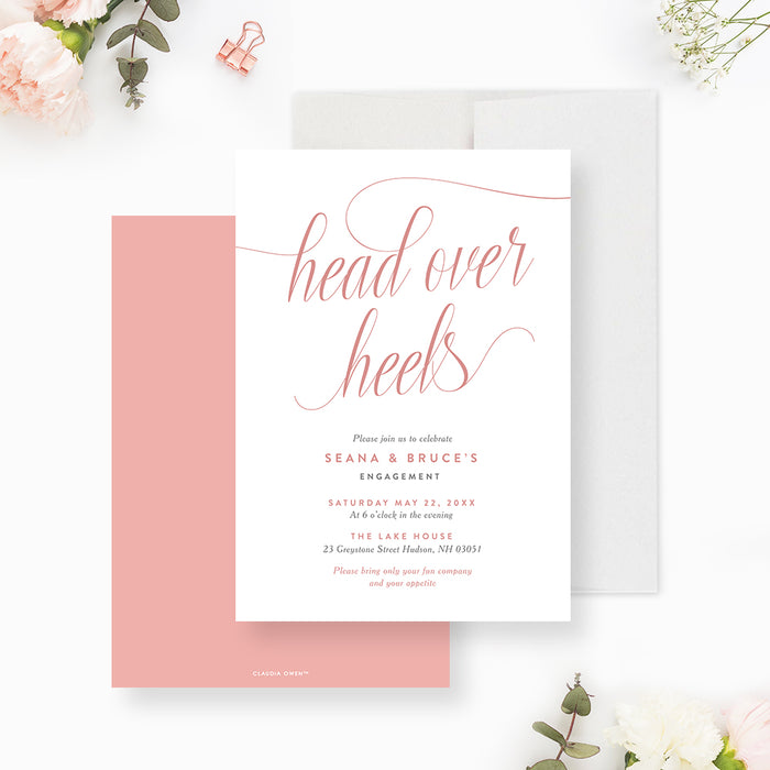 Romantic engagement invitation featuring “head over heels” in blush pink script with elegant minimalist layout-front-back
