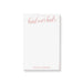 Personalized blush notepad featuring “head over heels” script with couple’s name at the bottom in elegant lettering