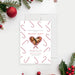 holiday party photo invitation with candy cane pattern, heart-shaped family photo, and personalized Christmas party details-front