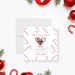 Christmas save the date photo card with candy cane pattern, heart-shaped photo frame, and personalized holiday details-front