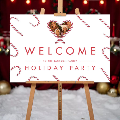 Holiday welcome sign featuring a family photo inside a heart-shaped candy cane frame with festive candy cane pattern and Christmas party welcome message.