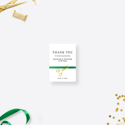 a thank card with a pair of scissors and a green ribbon