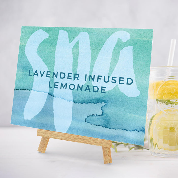 a glass of lemonade next to a sign that says lavender infused lemonade