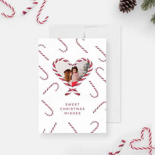 a card with a picture of a couple in a heart surrounded by candy canes