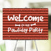 Red-striped pawliday party welcome sign with playful white lettering, snow dots, and bone accents, perfect for pet-friendly holiday celebrations.