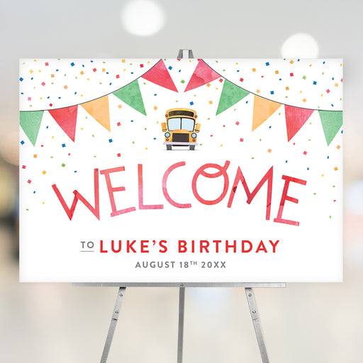 Colorful kids' birthday welcome sign featuring a school bus, confetti, and party bunting, displayed on an easel at the birthday party entrance.