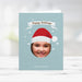 Kids holiday photo card template featuring child photo cutout, Santa hat illustration, snowflake background and Happy Holidays text in a festive digital Christmas design