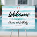 kids pool party welcome sign with watercolor aqua stripes, lifebuoy accent, and birthday details displayed on an easel