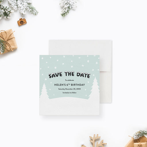 Kids winter birthday save the date card with snowflakes, pine trees, and soft pastel snowy background-front