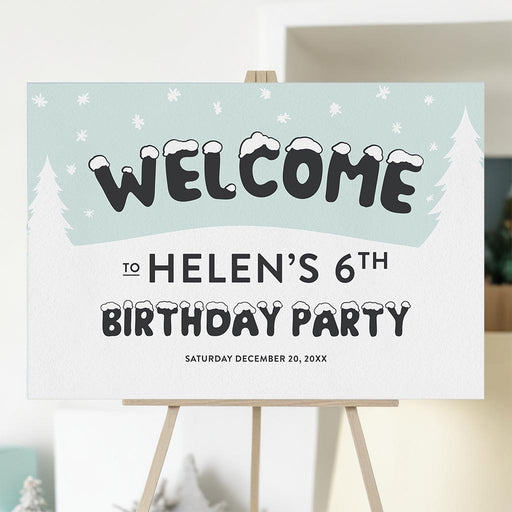 Winter birthday welcome sign with snowflakes, snowy lettering, and pine trees for a child’s birthday party entrance.