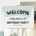 Winter birthday welcome sign with snowflakes, snowy lettering, and pine trees for a child’s birthday party entrance.