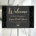 Personalized bridal shower welcome sign featuring black lace design and elegant lettering, displayed on an easel.