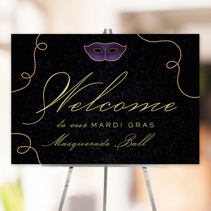 Elegant Mardi Gras masquerade ball welcome sign featuring a black background with gold script, purple mask graphic, and gold bead accents.