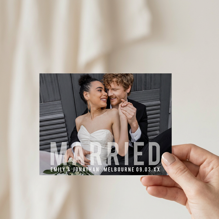 Married photo announcement held in hand