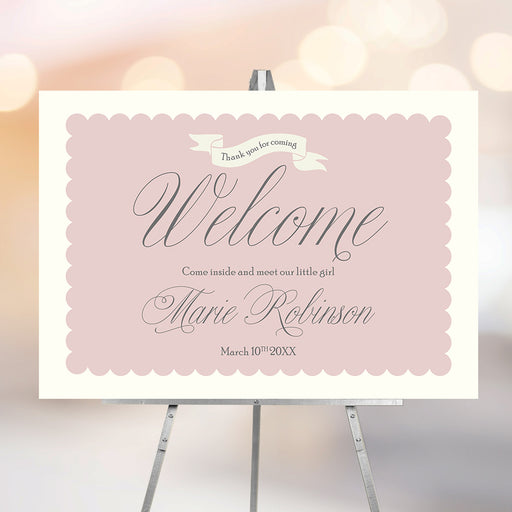 Blush pink Sip and See welcome sign personalized with baby’s name and date, elegant baby party decoration for meet and greet celebrations.
