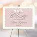 Blush pink Sip and See welcome sign personalized with baby’s name and date, elegant baby party decoration for meet and greet celebrations.