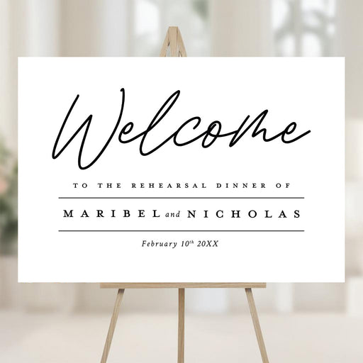 Custom minimalist rehearsal dinner welcome sign featuring the couple’s names and date, displayed on an easel at the event entrance.