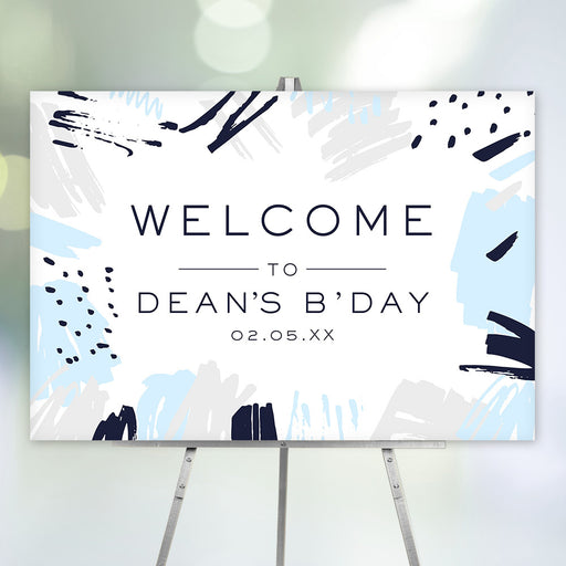 modern personalized birthday welcome sign with abstract blue and gray brushstroke artwork and minimalist typography on easel display.