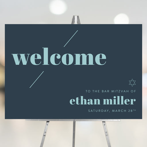 Navy blue Bar Mitzvah welcome sign with light blue text and Star of David, displayed on an easel at the event entrance.