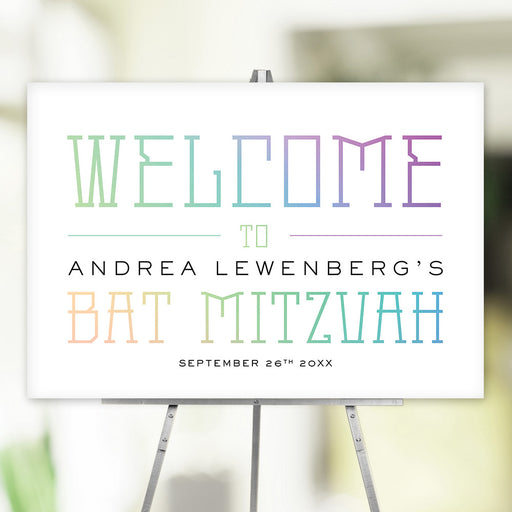 Custom Bat Mitzvah welcome sign with pastel lettering, personalized with name and date, displayed on easel for event decor.